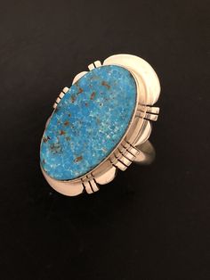 "This Turquoise gemstone is intriguing with its matrix. The Turquoise is Kingman Turquoise and has a deep blue Turquoise. Kingman Turquoise is found just off the highway about 20 miles Northwest of Kingman, Arizona. This is the highway to Las Vegas, Nevada. The ring is stamped, Sterling Silver and Paul Sanchez the artist Hallmark. Paul is a well-known silversmith and lives in the Albuquerque, New Mexico area. The ring weighs 10.22 grams and the ring measures 1 1/8\" X 7/8\" in size. This stunnin Southwestern Style Blue Turquoise Ring With Natural Stones, Southwestern Blue Turquoise Ring With Natural Stones, Southwestern Blue Jewelry With Large Stone, Southwestern Style Blue Jewelry With Large Stone, Southwestern Blue Large Stone Jewelry, Southwestern Turquoise Chrysocolla Ring, Southwestern Oval Turquoise Ring With Natural Stones, Southwestern Chrysocolla Turquoise Ring, Southwestern Blue Oval Jewelry