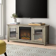 a flat screen tv mounted to the side of a wall next to a fire place