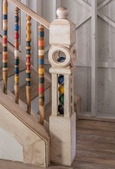 an old wooden stair case with marbles and abacusts on the bottom handrail