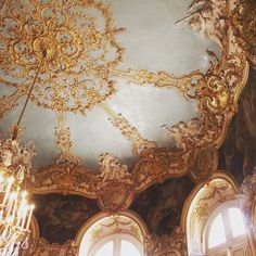 an ornately decorated ceiling with chandeliers and windows