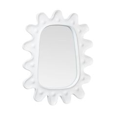 a white mirror sitting on top of a table