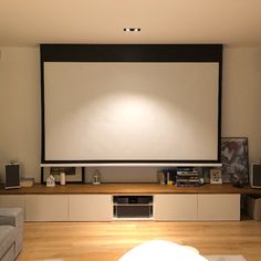 a large screen mounted to the wall in a living room