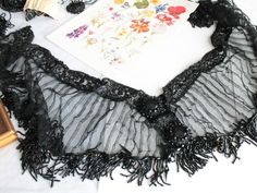 "Jet beaded scarf, black antique beads, jet trim, luxury scarf, antique beaded scarf, antique bead embroidery The whole thing is embroidered on black pleated tulle. Hundreds of pearls have been embroidered on this set (magnificent embroidery work). Length: 95 cm - 1.03 yards Height: 16/23 cm - 6 1/4\" - 8 3/4\" Late 19th century: around 1880 Two very large buttons adorn the front of the item. They are decorated with a jet button surrounded by two rows of jet beads. The whole is decorated with a Luxury Scarf, Beaded Scarf, Pleated Tulle, Luxury Scarves, Large Buttons, Bead Embroidery, Shawls And Wraps, Beaded Embroidery, Scarf Accessory