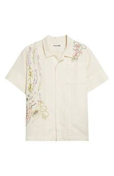 The husband-and-wife design duo brings its art-centric approach to fashion with a short-sleeved button-up vividly stitched with artisanal floral embroidery. A soft, lightweight blend of cotton and linen brings ultimate freshness to your ensemble. 27 1/2" length, 46" chest (size medium) Front button closure Notched collar Short sleeves Chest patch pocket 55% cotton, 45% linen Hand wash, line dry Imported Designer Clothing Asian Owned/Founded Designer Embroidered Summer Tops, Designer Embroidered Tops For Summer, Designer Embroidered Shirt For Spring, Story Mfg, Hand Embroidered Flowers, Camp Shirt, Embroidered Shorts, Notched Collar, Camping Shirt