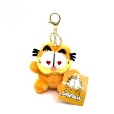 a small stuffed animal keychain with a tag attached to it's side