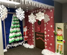 an office decorated for christmas with snowflakes and santa's helper decorations