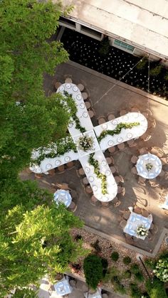 an aerial view of tables and umbrellas set up in the shape of a cross