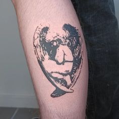 a man with a tattoo on his arm holding a surfboard in the shape of a heart