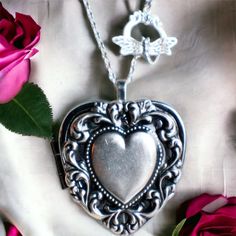 "Heart music box pendant. This heart shaped music box is inspired by the gorgeous music box pendants of era's gone by.  A heart shaped locket has been adorned with a silver ox stamping of a lacey edged floral heart with a solid heart center. The lacey edged floral heart has been covered in a clear resin to give a glass like finish and preserve the beauty of this musical pendant.  The locket opens and closes by pushing the little button on the side and reveals a tiny working music box that plays an 18 note musical tune.  Choose the music box tune you would like at checkout.To listen to the music box tunes, get more information on our music boxes and see our limited addition tune list, go to http://bit.ly/1VJ9Amj The inside front cover of the locket has a lacey floral finish.  You can leave Elegant Heart Necklace With Vintage Charm As Gift, Elegant Vintage Charm Locket Necklace For Valentine's Day, Charming Silver Heart Necklace, Vintage Double Heart Locket Necklace, Vintage Nickel-free Heart Necklace For Anniversary, Heart-shaped Locket Necklace With Vintage Charm, Heart Shaped Locket Necklace With Vintage Charm, Heart-shaped Locket Necklace With Vintage Charm For Gifts, Vintage Open Heart Necklace For Keepsake