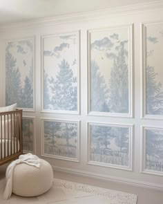 a baby's room with wallpaper and a crib in the foreground