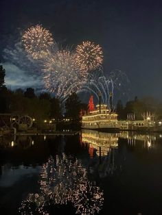 fireworks are lit up in the sky above a river