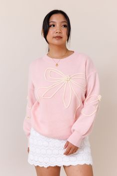 Our Tangled Up Sweater is a cozy and blush pink sweater. It features a textured bow overlay design throughout the body and sleeves. It has a crew neckline and ribbed trims that provide a perfect fit. It has a super soft fabric.Model wears a size smallModel is 5'1"39% Acrylic, 31% Polyester, 30% PolyamideSize small measurements:Bust: 22"Waist: 34" Pink Crew Neck Knit Top, Long Sleeve Sweater With Bow For Spring, Spring Long Sleeve Sweater With Bow, Feminine Crew Neck Winter Sweater, Feminine Crew Neck Sweater For Winter, Pink Knit Top For Spring, Feminine Soft Knit Sweater For Spring, Feminine Soft Knit Sweater, Soft Knit Feminine Sweater