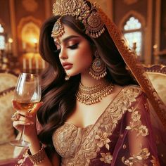 a woman in a bridal outfit holding a glass of wine