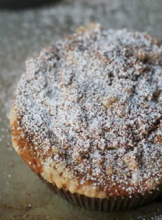 a powdered sugar covered muffin sitting on top of a table