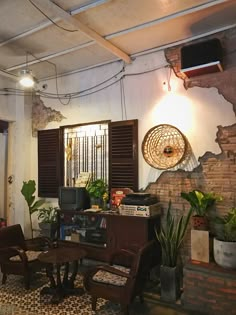 a living room filled with furniture and lots of plants on top of a tiled floor