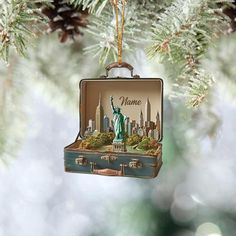 an ornament shaped like the statue of liberty hanging from a christmas tree