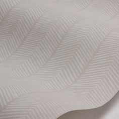 a close up view of a white wallpaper with an interesting pattern on it's surface