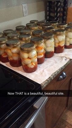 many jars filled with food sitting on top of a kitchen counter next to an oven