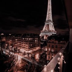 the eiffel tower is lit up at night