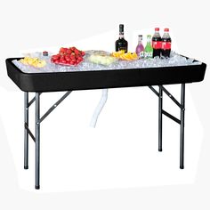 an ice table with drinks and fruit on it