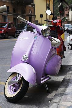 a purple scooter is parked on the street