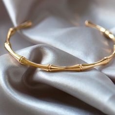 This bamboo cuff bangle is made from Stainless Steel and plated with 18k gold plating. It is a lightweight and comfortable piece of jewellery, with an unusual design. It looks fabulous when worn solo, or alternatively stack it up with your favourite bangles and bracelets for a striking look. Made from stainless steel plated with 18k gold Your order will be carefully packed in our branded packaging. ♥ If you have any questions about this listing, please do message me... ★ Click here to see more like this : https://www.etsy.com/uk/shop/SavannahandsageShop?ref=seller-platform-mcnav Other info ♥ Tarnish free FAST & FREE UK SHIPPING! All orders processed and shipped within 24 / 48 hours. ★ Copyright © 2023 - Savannah & Sage. All Rights Reserved. Gold Cuff Bangle, Bangles And Bracelets, Modern Bracelet, Boho Bangle, The Bangles, Modern Bracelets, Bamboo Design, Earrings Design, Stainless Steel Plate