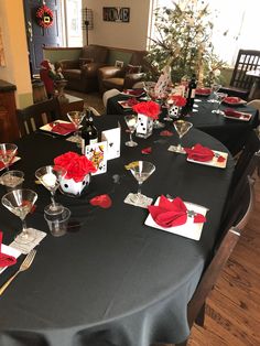 the table is set with red napkins and wine glasses for valentine's day