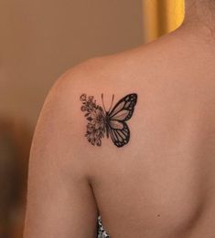 a woman with a butterfly tattoo on her shoulder