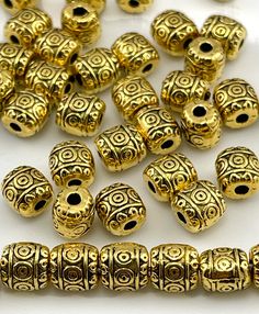 gold plated beads with intricate designs on them