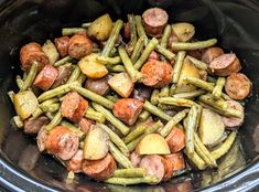 cooked potatoes and green beans in a slow cooker with meatballs on the side