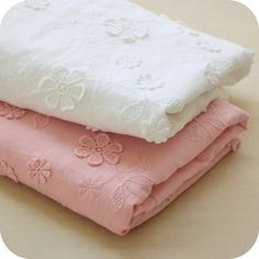 three pieces of pink and white fabric stacked on top of each other in different patterns