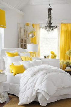 a bedroom with yellow curtains and white bedding