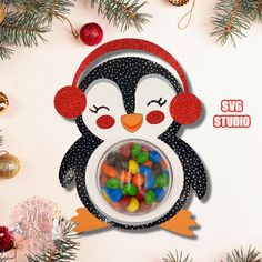 a penguin holding a bowl filled with candy