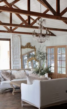 a living room filled with furniture and a chandelier