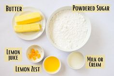 ingredients to make lemon cake laid out on a white table with labels labeled in english