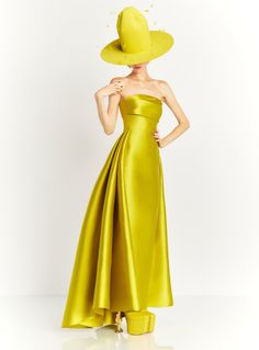 a woman in a yellow dress and hat