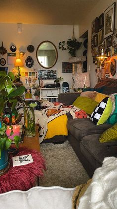 a living room filled with furniture and lots of plants on top of the couches