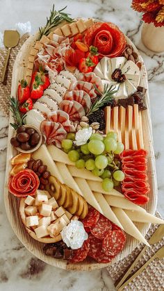 an assortment of cheeses and meats on a platter