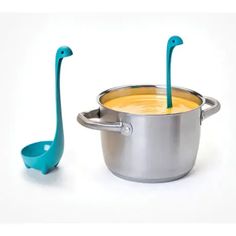 two spoons sticking out of a pot with food in it and one on the side