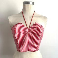 Cute Candy Stripe Bustier!  Handmade circa 1980's in the style of a 1950's Suntop. *100% Sturdy Cotton * Tailored Fit (No Stretch)    * Nylon Zip Back Closure  * Extreme Structured Bustline with neck tie detail   * Extreme Boned Bust (flexy plastic boning) * Red & White Colourway in Candy Stripe Pattern Quiet Cruedly Handmade but still very wearable! was perhaps a costume piece originally. Best fit Bust - 34" inches Max (slim back but larger bust is the fit it is designed for) Best fit Waist - 2 Fitted Cotton Halter Top With Built-in Bra, Red Summer Corset With Built-in Bra, Vintage Summer Top With Built-in Bra, Summer Halter Neck Fitted Corset, Fitted Retro Tank Top, Fitted Strapless Tank Top With Boned Bodice, Red Retro Spring Tank Top, Retro Red Spring Tank Top, Red Fitted Halter Top With Built-in Bra