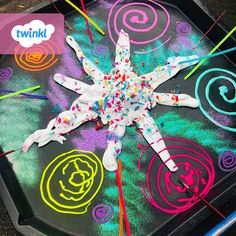 a star made out of colored crayons on top of a black tray