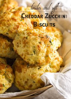 a basket filled with cheesy biscuits sitting on top of a white table cloth