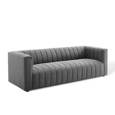 a gray couch sitting on top of a white floor