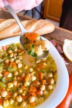 a spoonful of soup with chickpeas and carrots