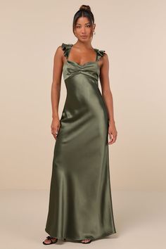 The Lulus Exuberant Luxury Olive Green Ruffled Lace-Up Maxi Dress was made for any special occasion that needs a sensational look to match! Sleek woven satin shapes this lovely dress that features a sleeveless bodice with a ruched detail at the center, creating chic pleating and a sweetheart neckline. Slender, ruffle-trimmed straps flow into a trendy lace-up design across an open back. The high, empire-style waist tops a figure-skimming, A-line skirt that cascades down to a sweeping maxi hem. Hi Satin Tie Dress, Old Fashioned Bridesmaid Dresses, Satin Eucalyptus Bridesmaid Dress, Mossy Green Bridesmaid Dresses, Purple Green Bridesmaid Dresses, Classy Bridesmaids Dresses, Floor Length Green Dress, Reformation Green Dress, Olive Satin Bridesmaid Dresses