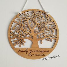 a wooden ornament with an image of a tree and the words family where life begins and love - never ends