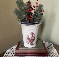 a potted plant sitting on top of a wooden table next to a stack of books