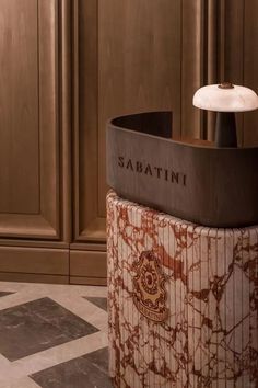 the sabatini bar is located on top of a marble pedestal in front of wooden cabinets