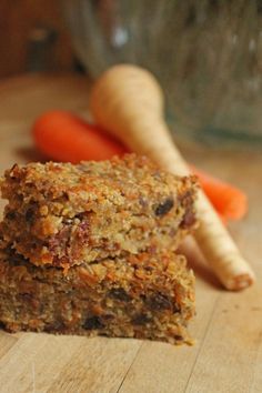 carrots and granola bars are sitting on a cutting board next to some carrots