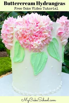 a white cake with pink and green flowers on it